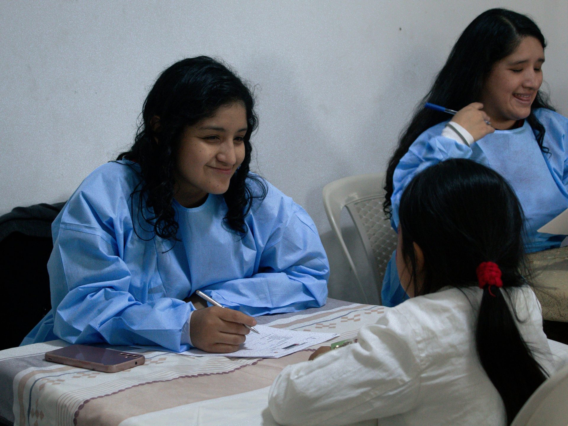 A group of girls sitting around a table